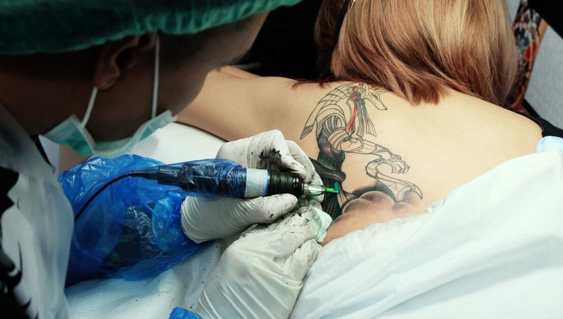 process of making a tattoo by professional girl artist